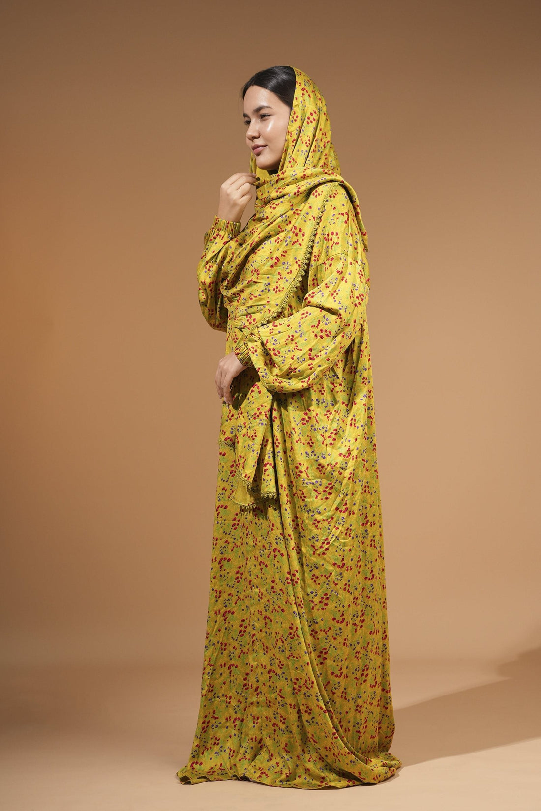 Woman wearing the green floral maxi dress with built-in scarf