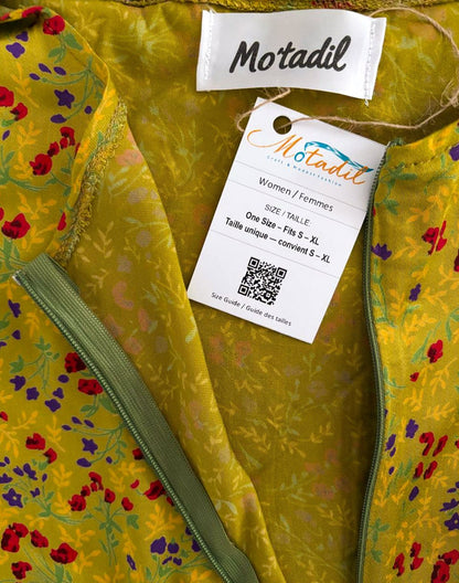 Inside of the green floral dress showing the MO'TADIL label and size tag