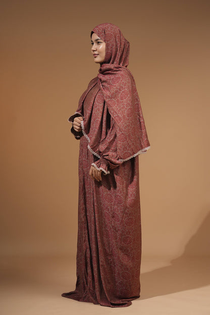 Woman wearing the maroon floral maxi dress with built-in scarf, side view