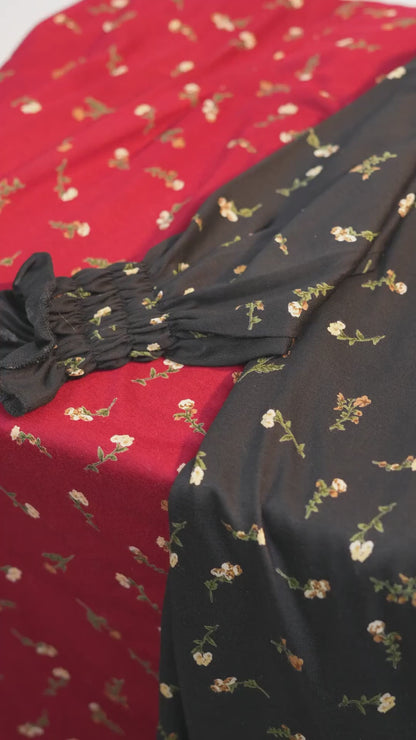 Video of the girls' cotton floral dresses with built-in scarf, showing the fabric and gathered cuffs